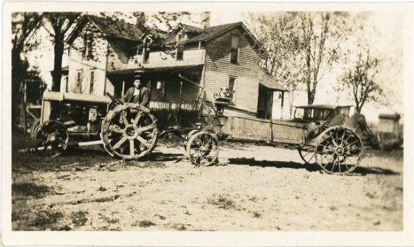 Man on a Tractor with Dog in a Wagon