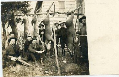 Men with Hanging Deer