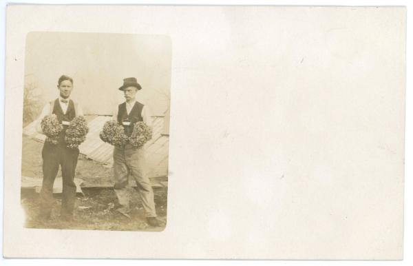 Two Men Holding a Harvest