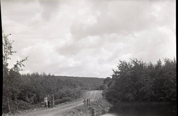 Men and Woman on Dirt Road
