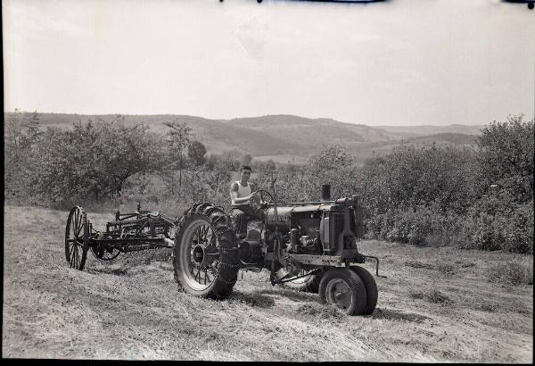 Young Man on Tractor Pulling Side Delivery Rake