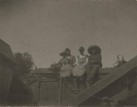 Group of Women Seated on a Tresher