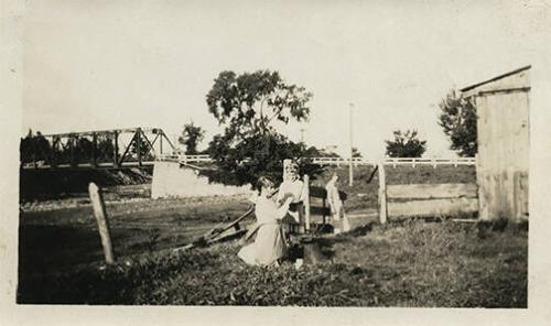 Three Girls Outdoors near a Barn 
