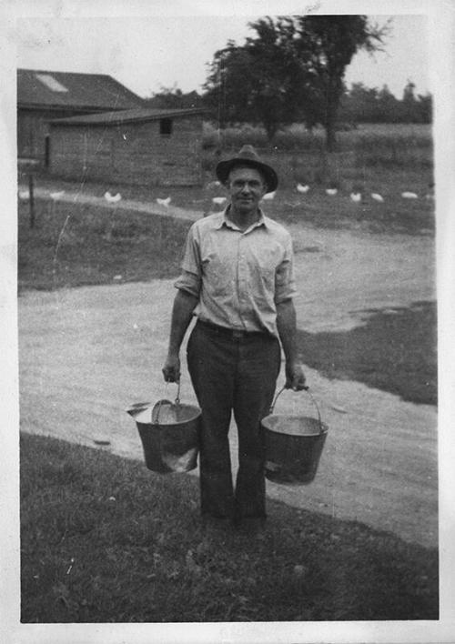 Farmer with Milk Pails 
