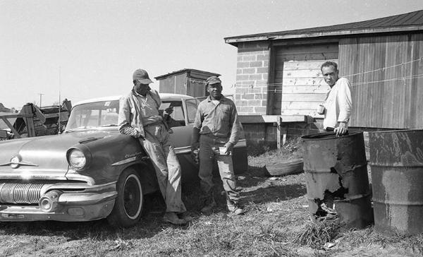 Men Standing Around a Car 2