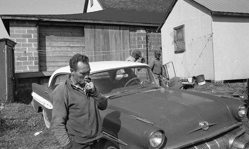 Men Standing Around a Car 3