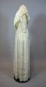 One-piece wedding dress of white cotton, seen from the side. Bodice is made with two long piece…