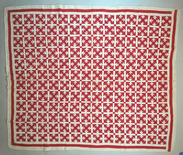 "Square on Square" quilt in red and white cotton. Each block is constructed with a small red sq…