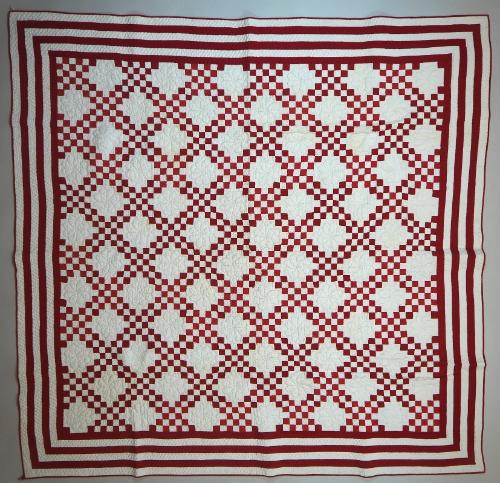 "Double Irish Chain" quilt in red and white cotton. The overall pattern consists of diagonal ro…
