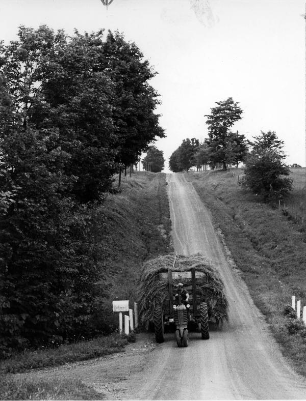A farmer hauling hay