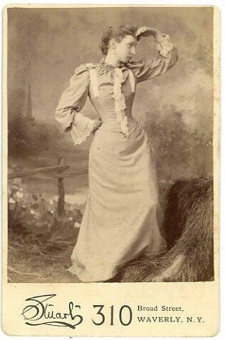 Woman Standing by a Hay Stack