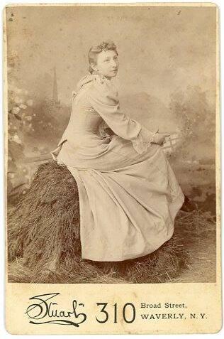 Woman Sitting on a Hay Stack