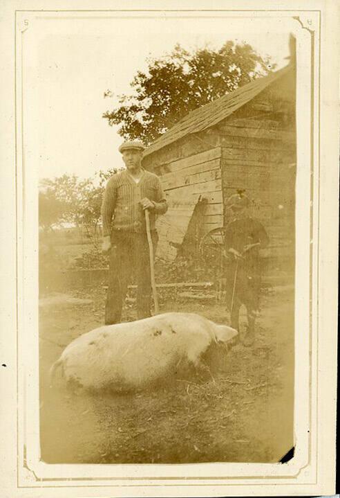 Man and Boy with Pig