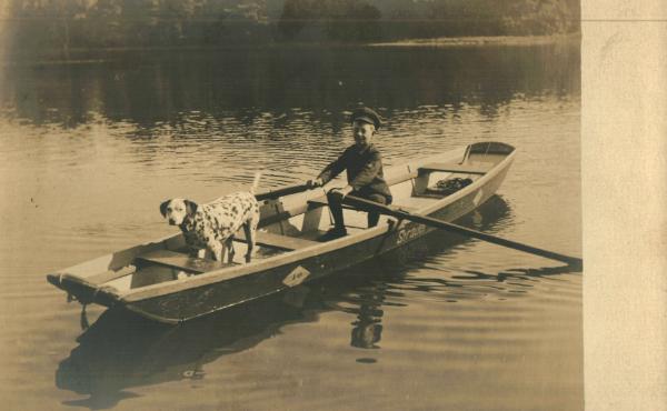 Boy and Dalmation in Boat