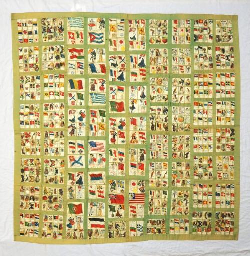 Quilt made of silk satin cigarette premiums showing flags of the world, people of different cou…