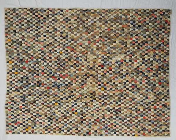 Postage Stamp quilt with many tiny pieces made of different cotton prints.