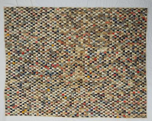 Postage Stamp quilt with many tiny pieces made of different cotton prints.