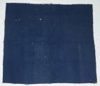 Whole-cloth quilt with dark blue wool top and light and dark brown wool back.