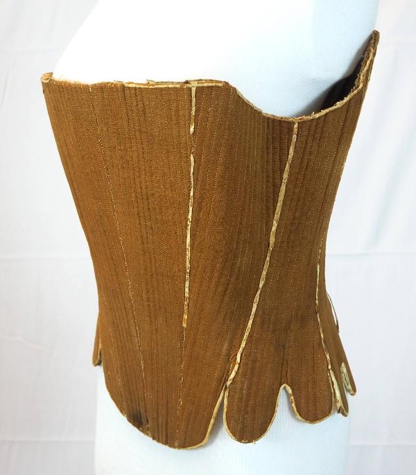A pair of strapless stays in brown wool, seen from a three-quarter front view.