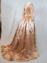 Pink satin gown and petticoat, seen from the side back.