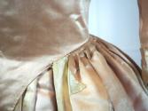 Close-up of side waist of pink satin gown.