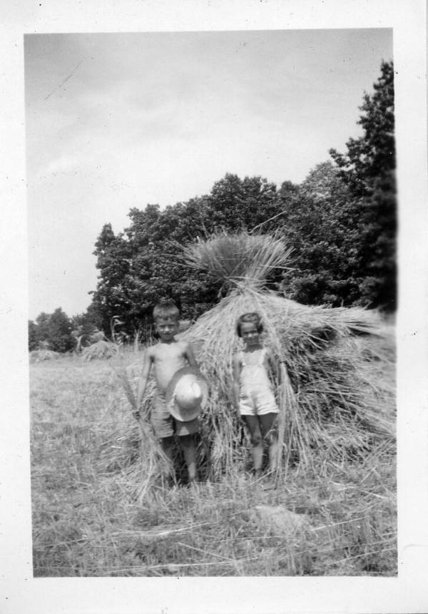Two Children in Front of a Grain Shock