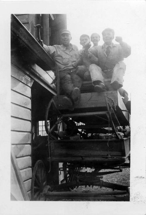 Two Men and Two Boys on a Wagon