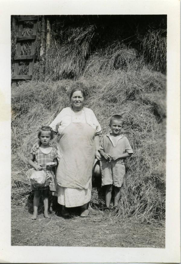Dezemo Children and Grandmother Posing in Front a Hay Mow