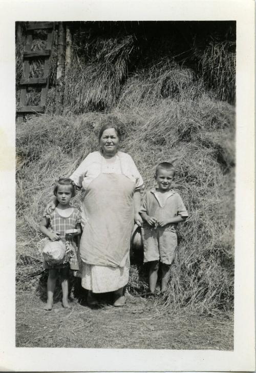 Dezemo Children and Grandmother Posing in Front a Hay Mow