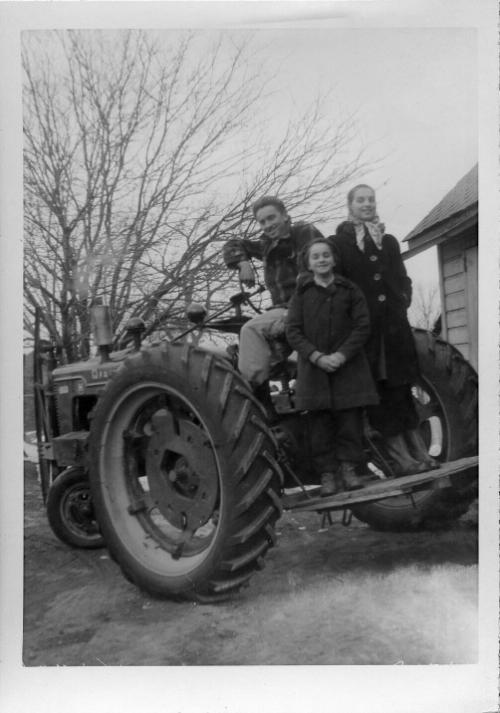George, Myrtle and Anna Dezemo on a Tractor, 1947