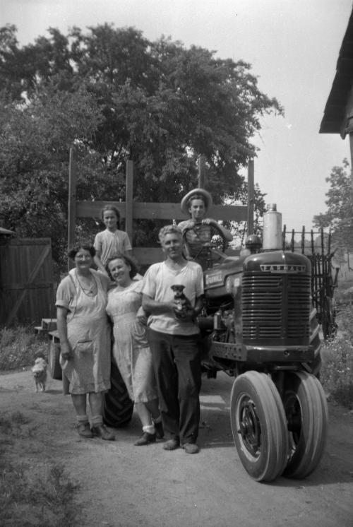 Family Posing with a Farmall H Tractor