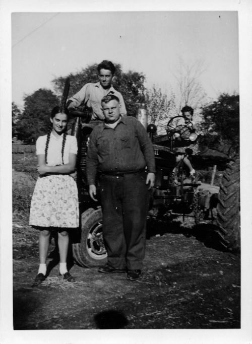George, Anna, Myrtle and Jim Dezemo with the Family Tractor