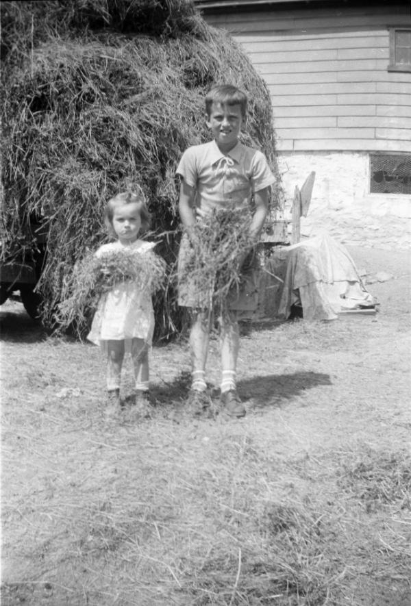 Two Children Holding Hay