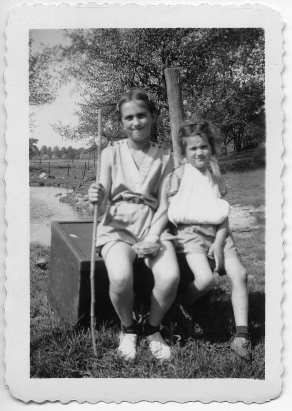 Two Girls Sitting by a Pond