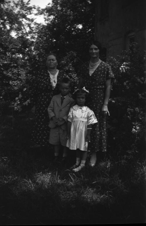 Two Women, a Young Boy and Young Girl Posing Outdoors
