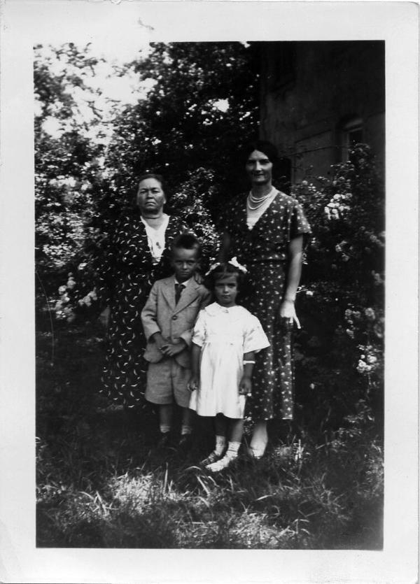 Two Women, a Young Boy and Young Girl Posing Outdoors