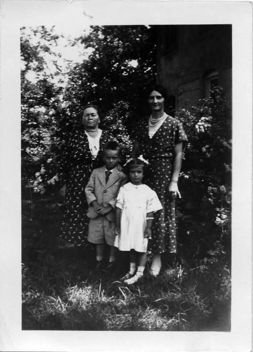 Two Women, a Young Boy and Young Girl Posing Outdoors