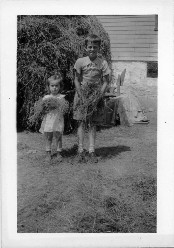 Two Children Holding Hay