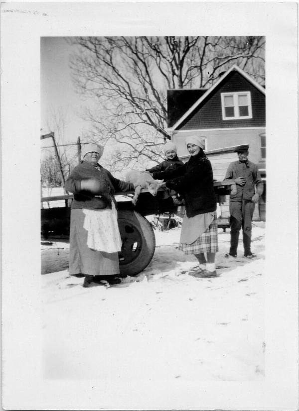 Grandma Dezemo, Young Boy and Others with Lamb