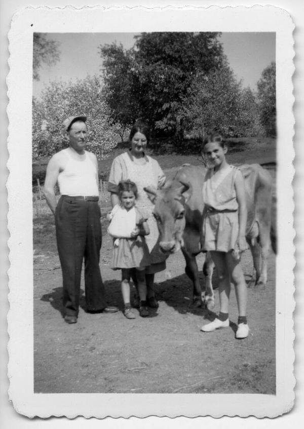Family Members Posing with Cow