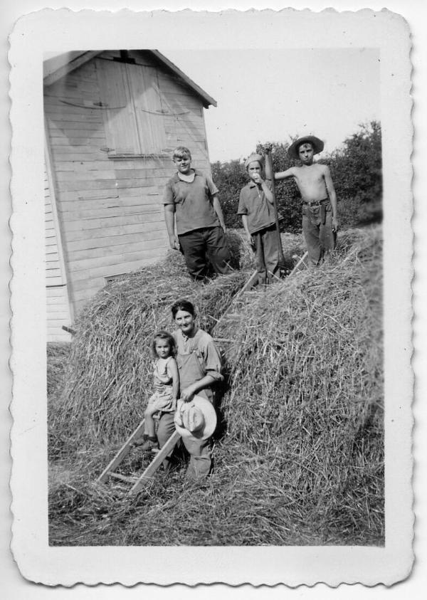 "Mama" Dezemo and Jim with Three Other Children in a Pile of Hay