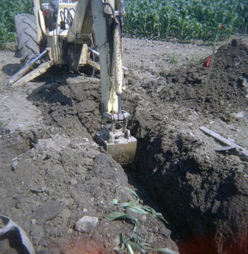 Backhoe Digging a Ditch