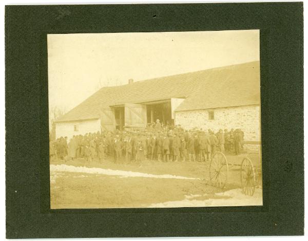 Large group Gathers in Front of a Barn