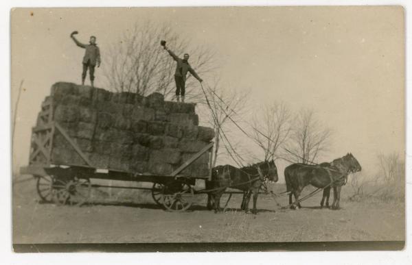 Two Men Atop a Hay Wagon
