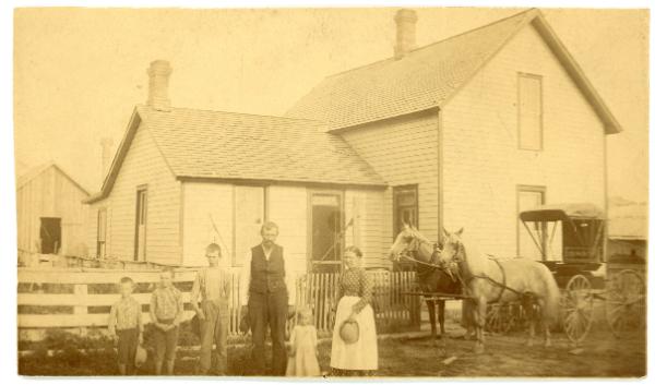 Family in Front of Home