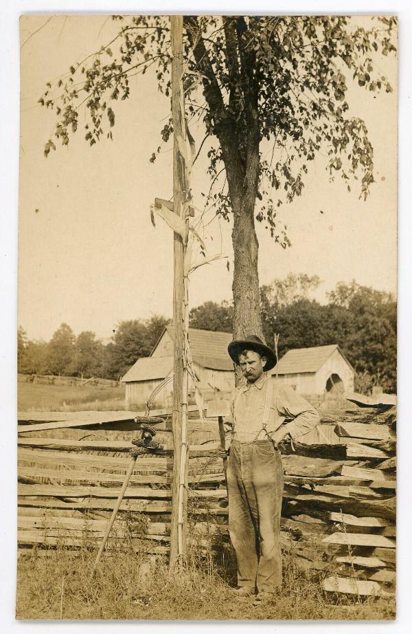 Man by a Fence
