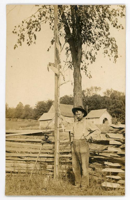 Man by a Fence