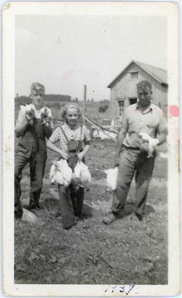 Three People Holding Chickens