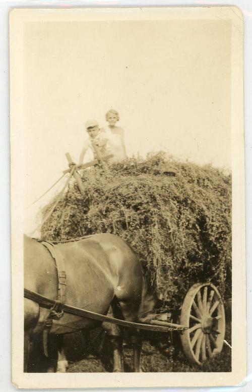 Two Children A Top a Wagon