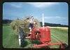 Woman Driving a Farmall C and Hay Wagon